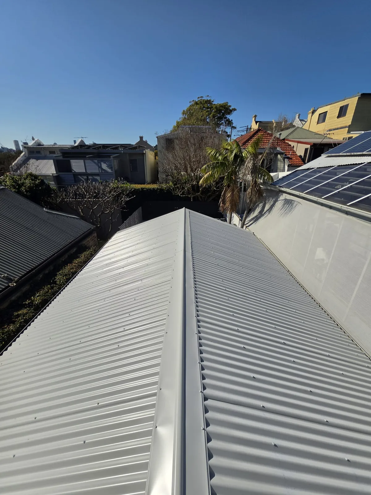 Neatly finished corrugated metal roof and ridge on the Annandale cottage after replacement