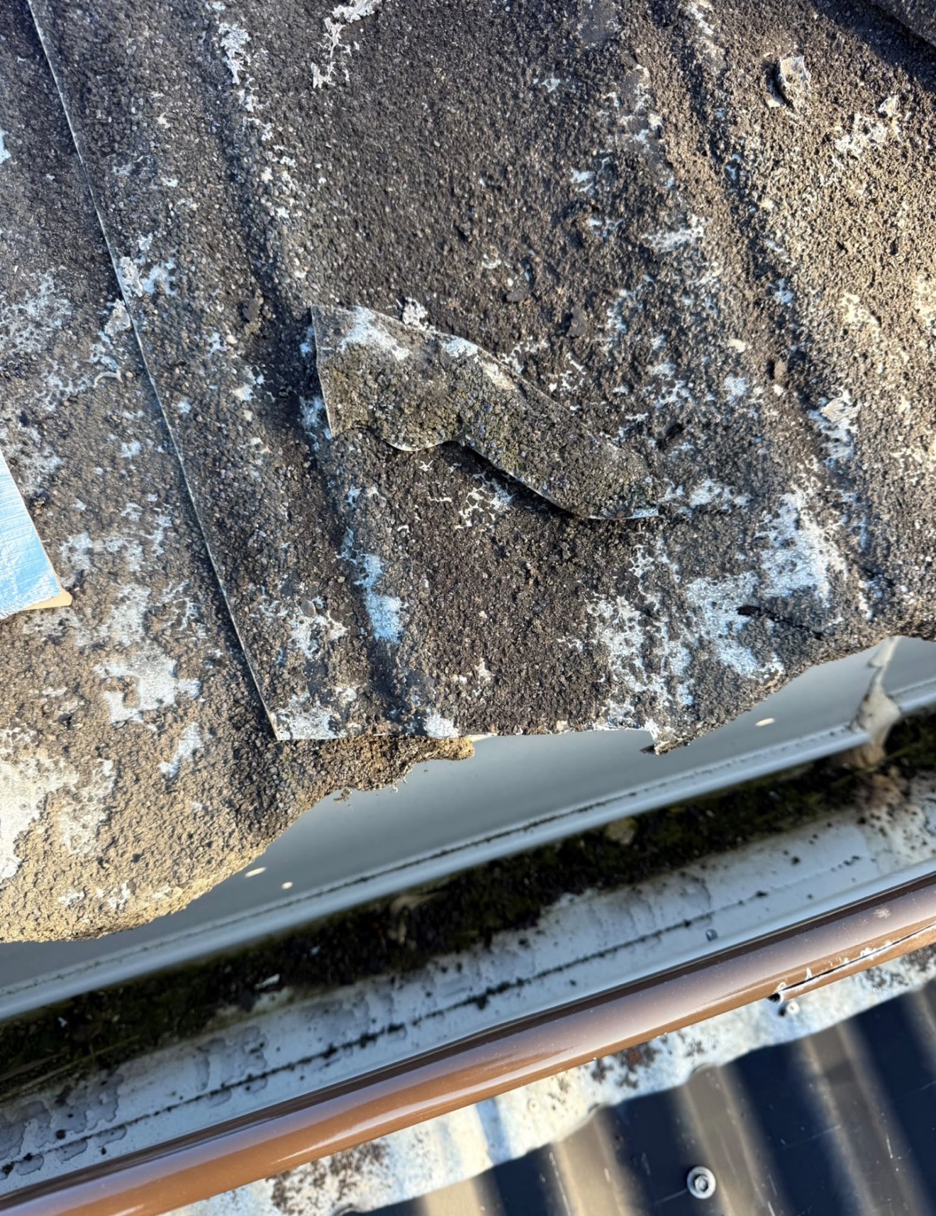 Deteriorated decramastic aluminium tile coating with confirmed asbestos — Croydon Park before removal