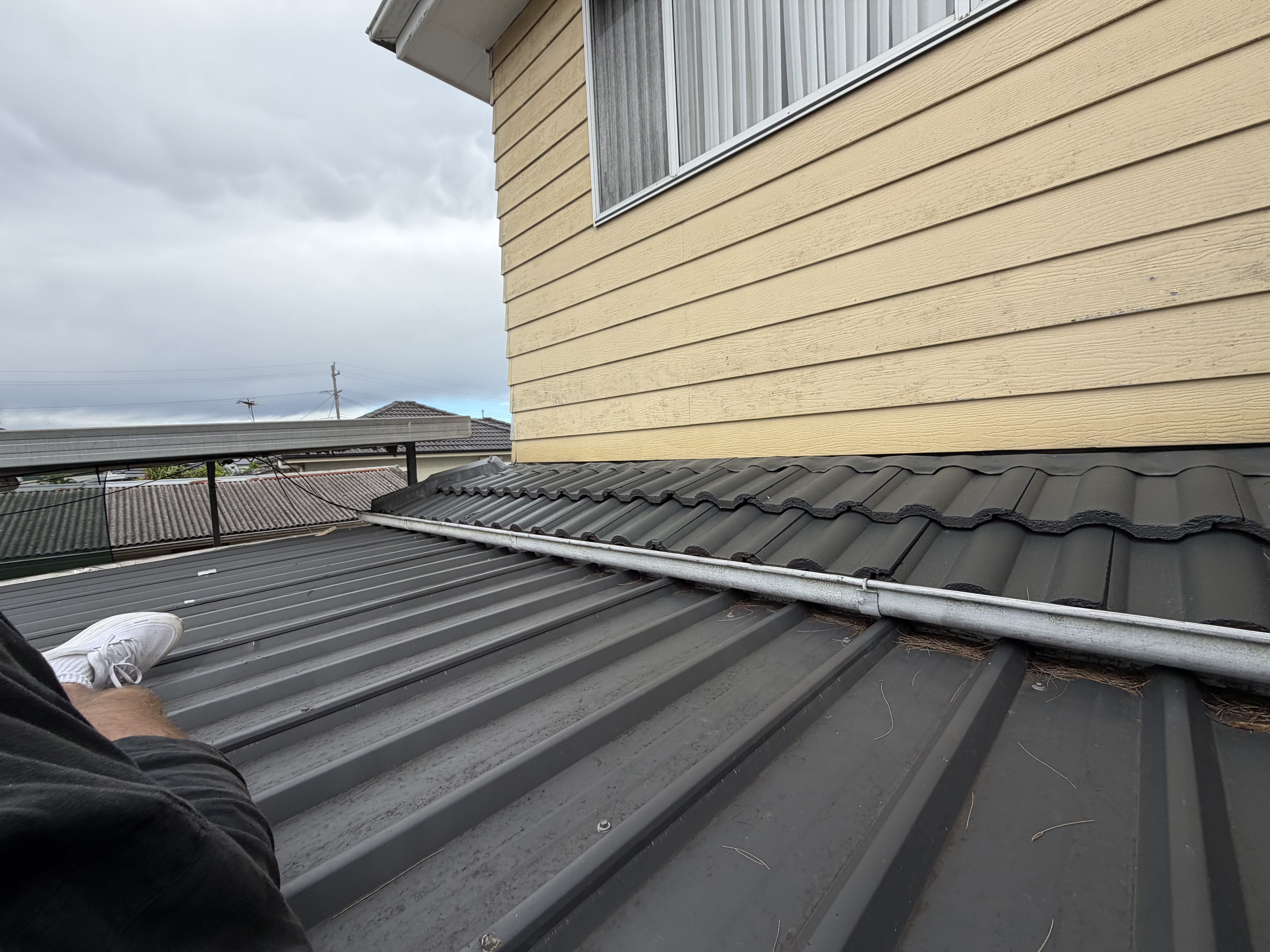 Old roof-to-tile junction before new flashings and Kliplok — Mount Pritchard
