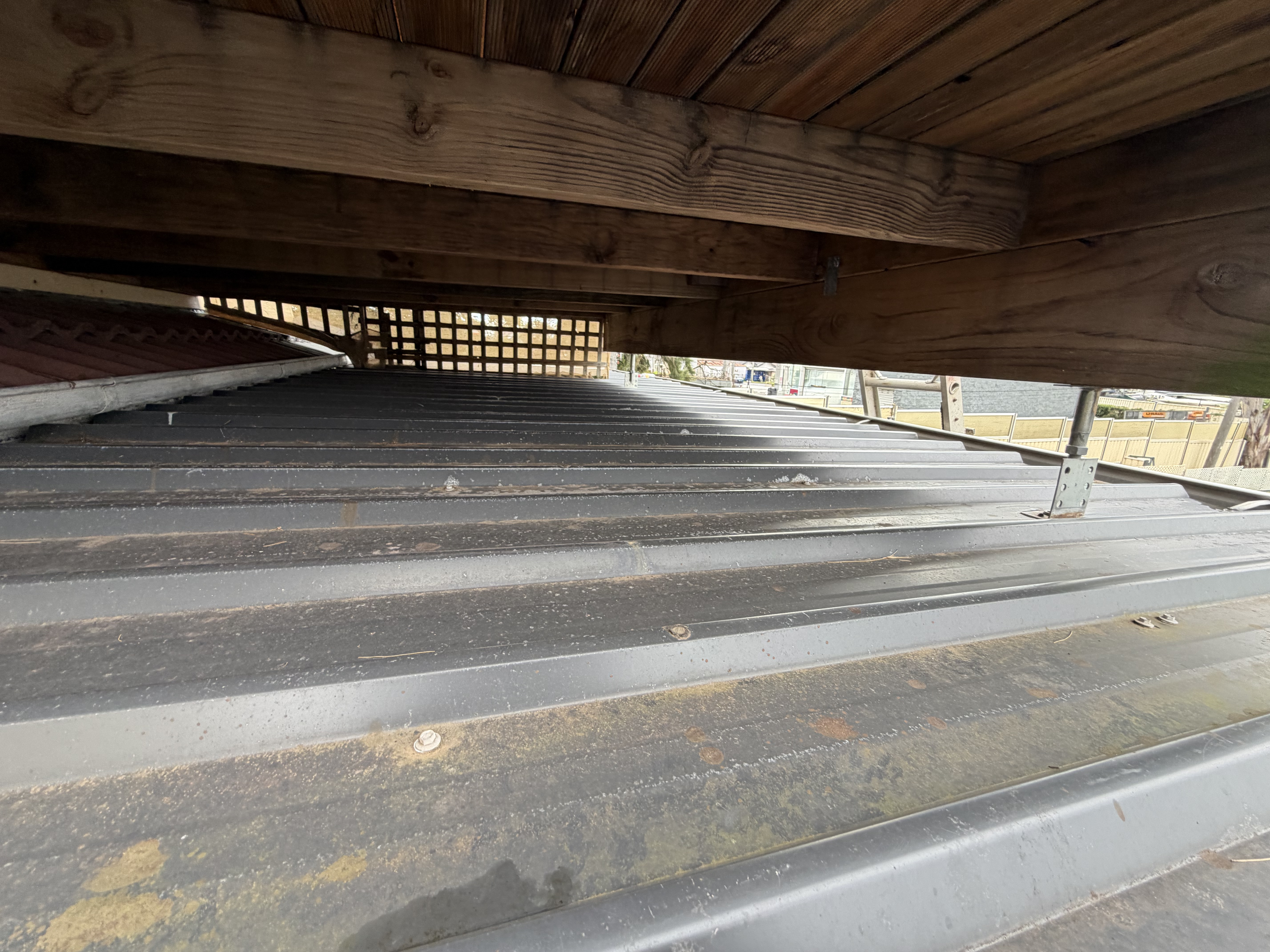 Original under-pitched corrugated roof beneath the balcony — Mount Pritchard before replacement
