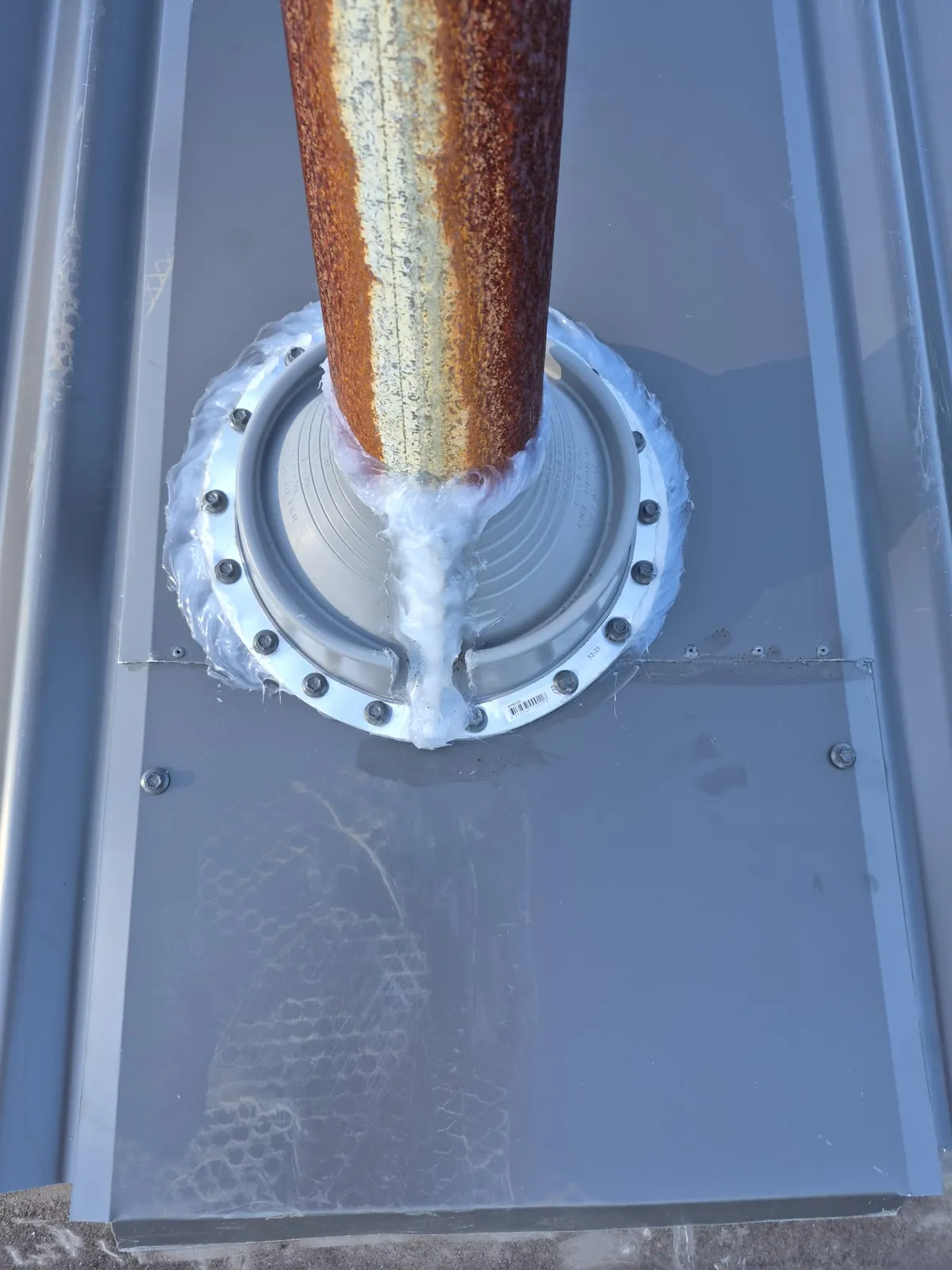 Close view of the finished flashing around an existing pipe through the new Ryde roof