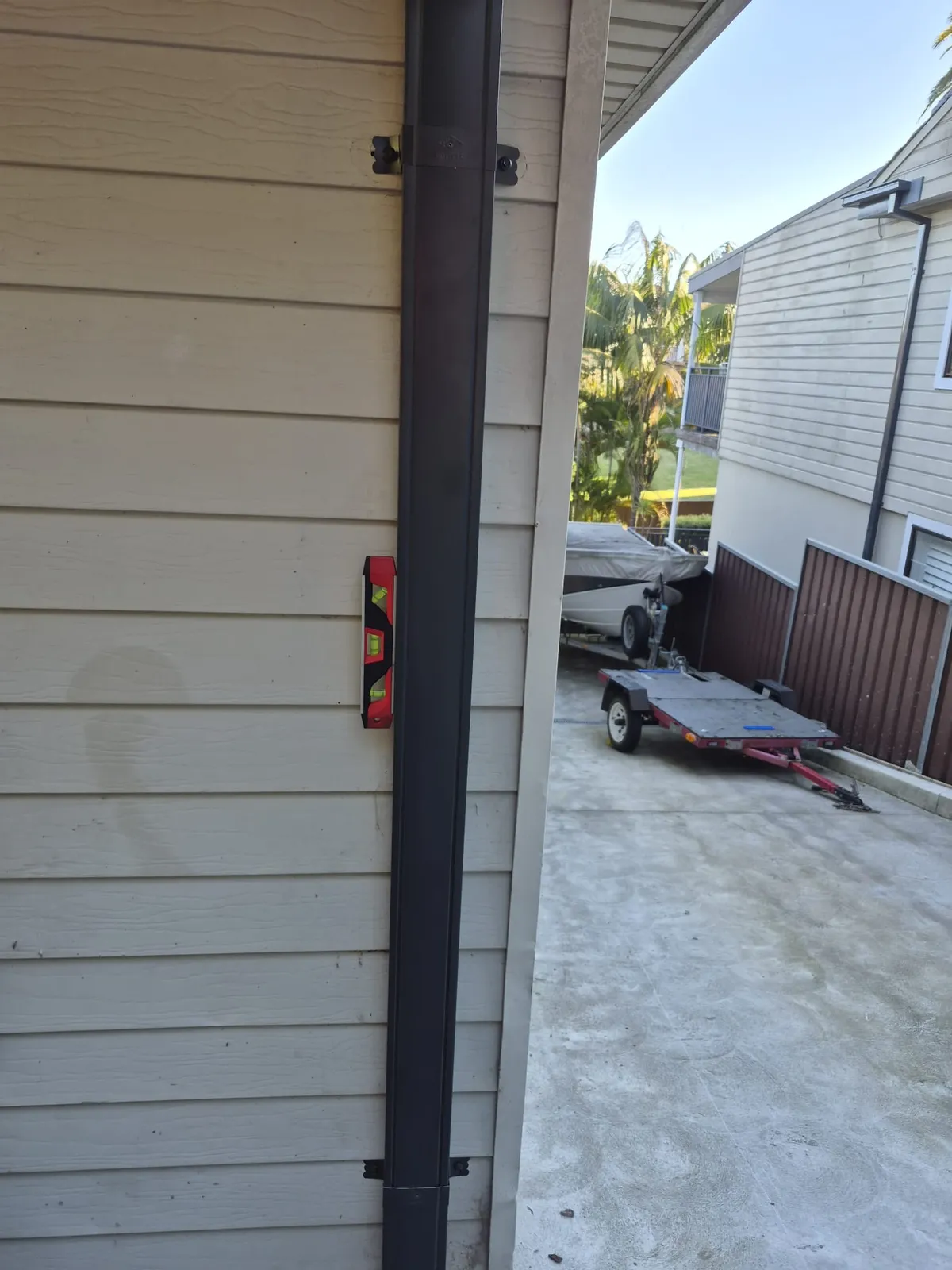 Downpipe and roof-edge detail at the Eagle Street, Ryde home after the roof replacement