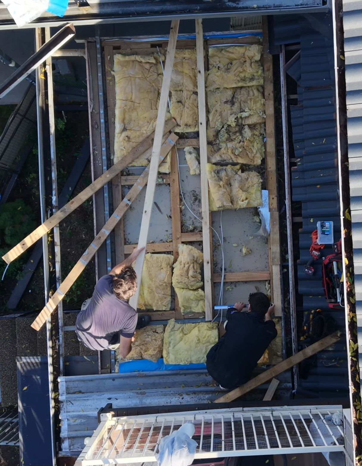 Roofing Goats crew installing insulation during a re-roof in Sydney